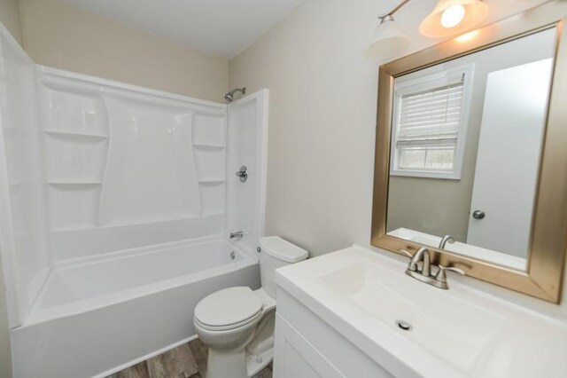 1765 Copperfield Ct, Clarksville, TN 37042 - bathroom with vanity, toilet, wood finished floors, and  shower combination