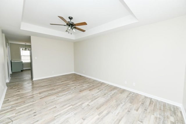 1765 Copperfield Ct, Clarksville, TN 37042 - unfurnished room featuring a ceiling fan, a raised ceiling, baseboards, and light wood-type flooring