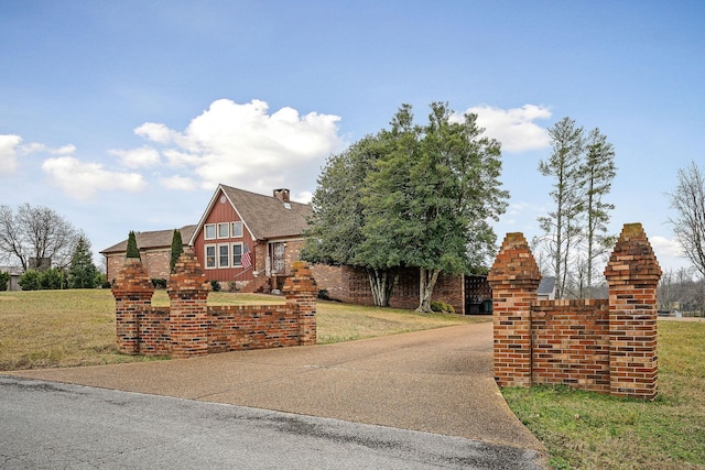 tudor home featuring a front lawn