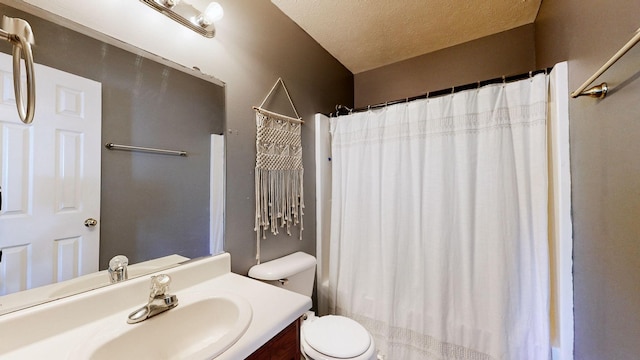 bathroom featuring walk in shower, vanity, toilet, and a textured ceiling