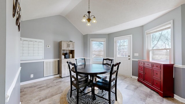 dining area featuring lofted ceiling, a chandelier, and a wealth of natural light