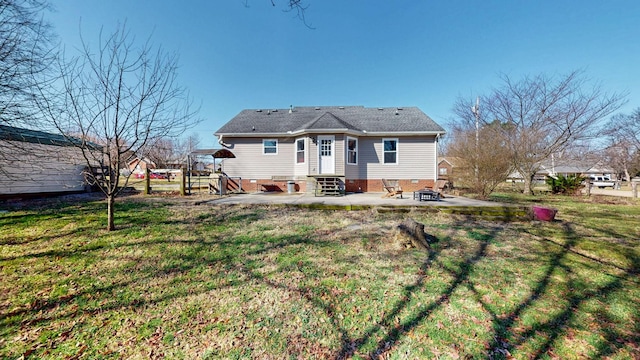 back of house with a patio area and a lawn