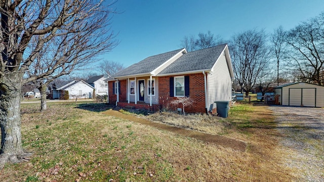 view of front of house with a shed and a front lawn