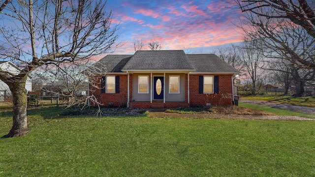 ranch-style home featuring a lawn