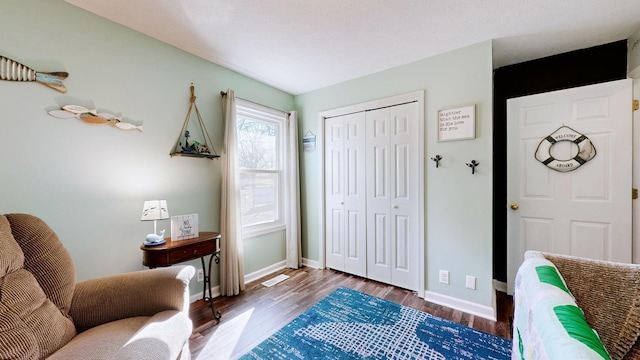 sitting room with dark hardwood / wood-style floors