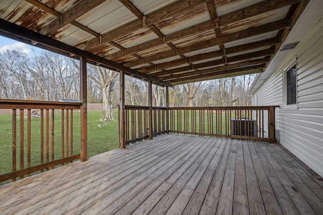 wooden terrace featuring a lawn