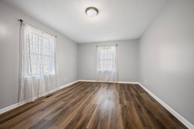 spare room featuring dark hardwood / wood-style floors