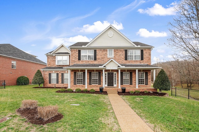 view of front of house with a front yard and covered porch