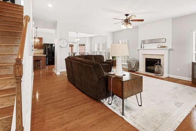 living room with hardwood / wood-style floors and ceiling fan