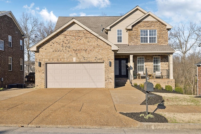 view of front facade featuring brick siding, a porch, driveway, and roof with shingles