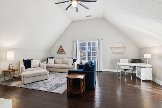 living room featuring ceiling fan, vaulted ceiling, dark wood-type flooring, and a textured ceiling