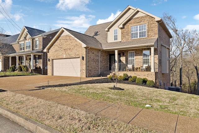 view of front of home with a front lawn, a porch, and a garage