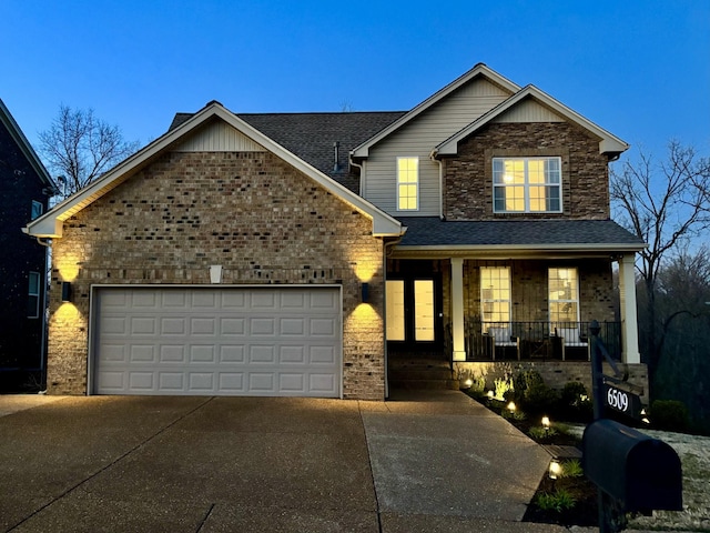 view of front of home featuring driveway, covered porch, a shingled roof, a garage, and brick siding