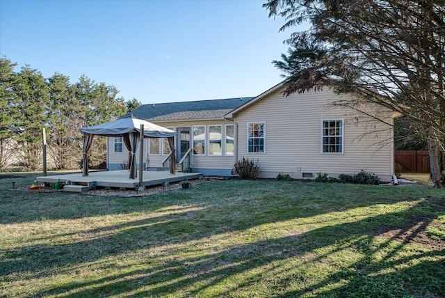 back of house with fence, a yard, a shingled roof, crawl space, and a deck