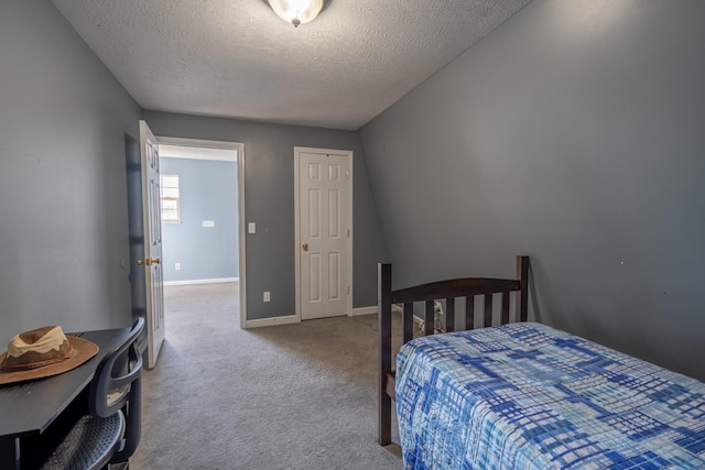 bedroom featuring light carpet and a textured ceiling