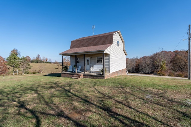 view of front of property with a porch and a front lawn