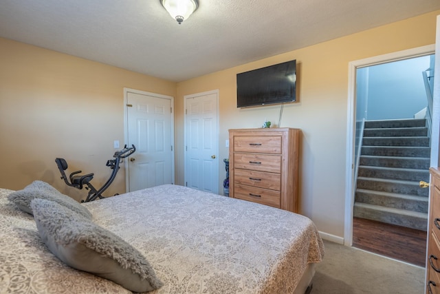 bedroom featuring carpet floors and a textured ceiling