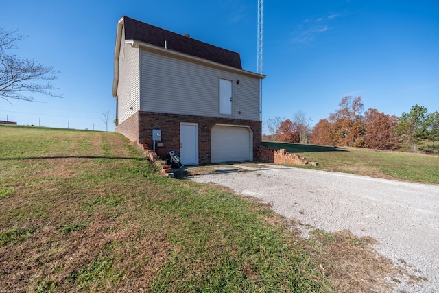 view of side of home with a garage and a yard