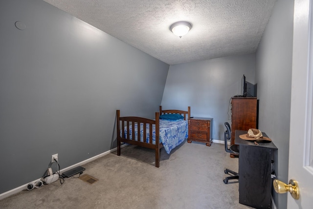 carpeted bedroom with a textured ceiling