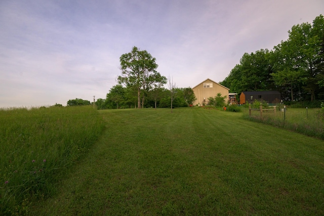 view of green lawn with an outbuilding