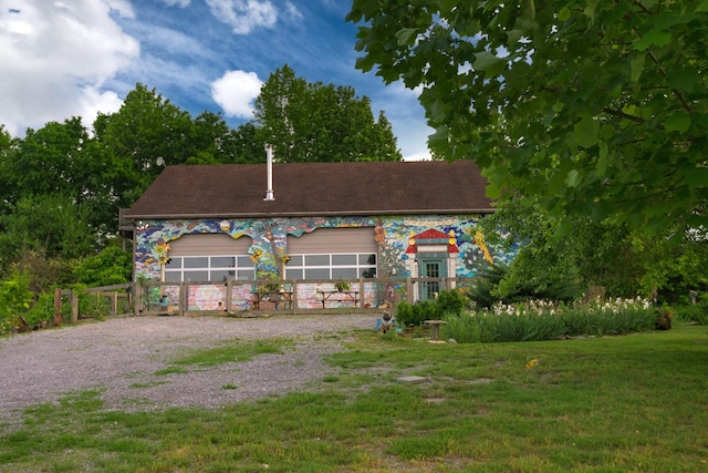 view of front of property with a front lawn and a detached garage