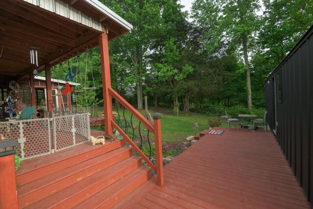 wooden deck with view of wooded area