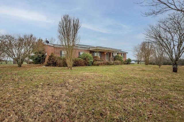 ranch-style home featuring a front yard and a porch