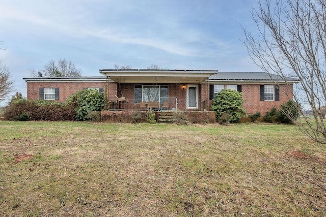 ranch-style home featuring a porch and a front lawn