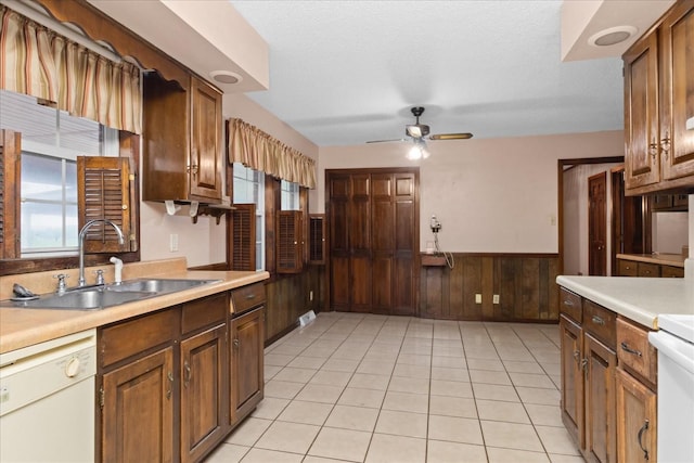 1144 Miller Rd, Lewisburg, TN 37091 - kitchen with a sink, white dishwasher, a wainscoted wall, ceiling fan, and light countertops