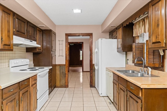1144 Miller Rd, Lewisburg, TN 37091 - kitchen with white appliances, a sink, under cabinet range hood, light countertops, and a wainscoted wall