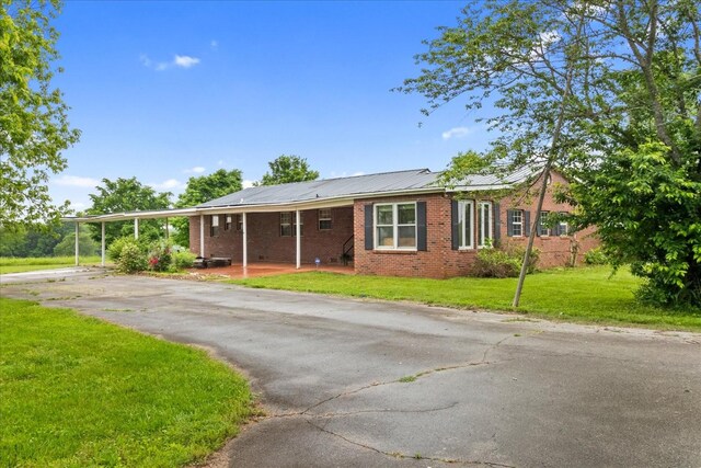 1144 Miller Rd, Lewisburg, TN 37091 - ranch-style house featuring driveway, brick siding, a front lawn, and metal roof