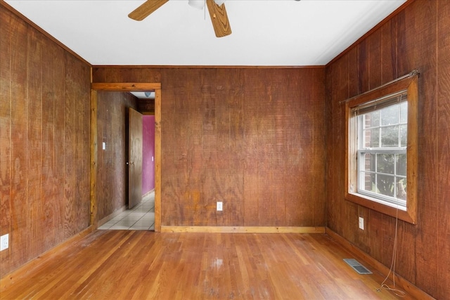 1144 Miller Rd, Lewisburg, TN 37091 - empty room featuring wood walls, light wood-style floors, and ceiling fan