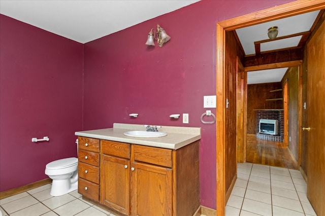 1144 Miller Rd, Lewisburg, TN 37091 - bathroom featuring tile patterned floors, toilet, a brick fireplace, and vanity