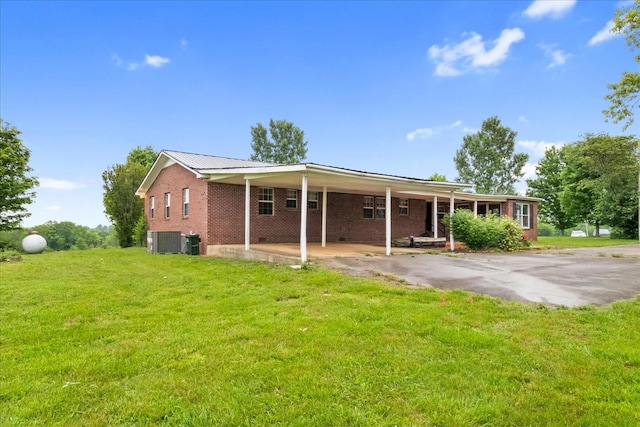 1144 Miller Rd, Lewisburg, TN 37091 - view of front facade with brick siding, a front yard, and central AC unit