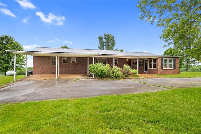 1144 Miller Rd, Lewisburg, TN 37091 - view of front of property featuring asphalt driveway, a front yard, brick siding, and a carport