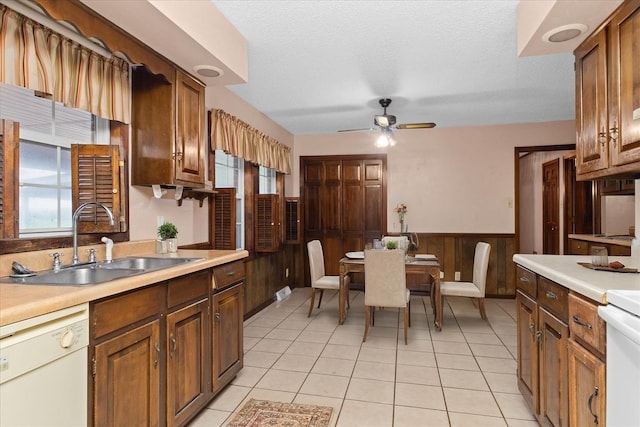 1144 Miller Rd, Lewisburg, TN 37091 - kitchen with a sink, white dishwasher, wainscoting, light countertops, and plenty of natural light