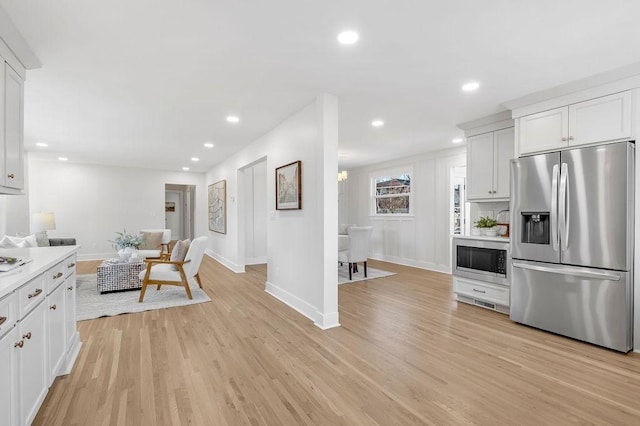 kitchen featuring white cabinetry, appliances with stainless steel finishes, and light hardwood / wood-style flooring