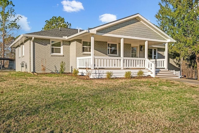 view of front of home with covered porch and a front lawn