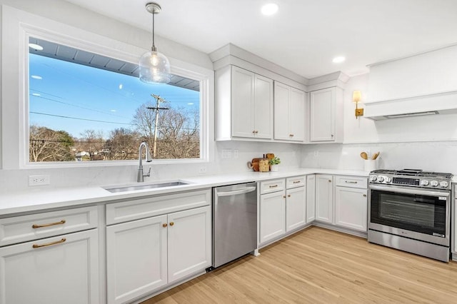 kitchen featuring sink, a wealth of natural light, white cabinets, and appliances with stainless steel finishes