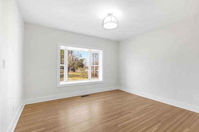 spare room featuring light wood-type flooring