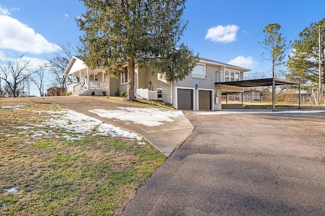 view of front of property featuring a garage and a porch