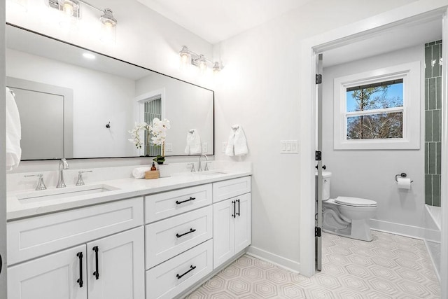 bathroom featuring vanity, tile patterned flooring, and toilet