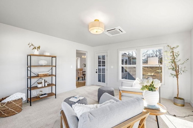 sitting room featuring light colored carpet