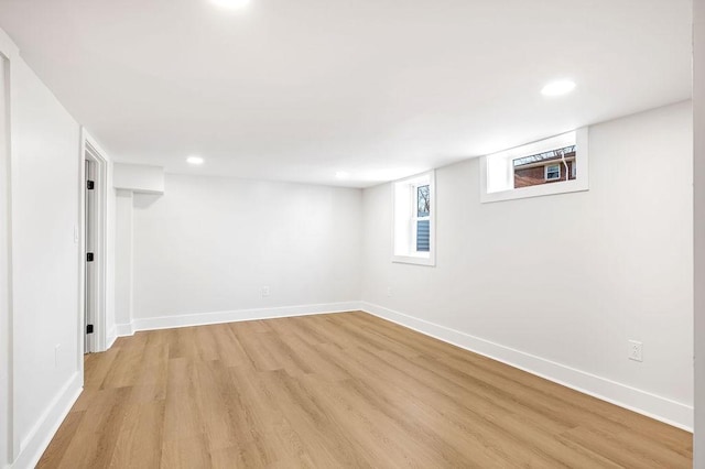 basement with light hardwood / wood-style flooring