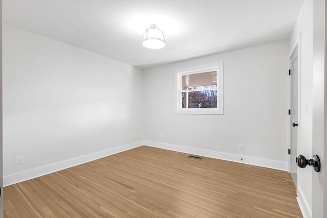 spare room featuring light hardwood / wood-style floors