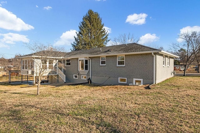 back of property featuring a carport and a yard