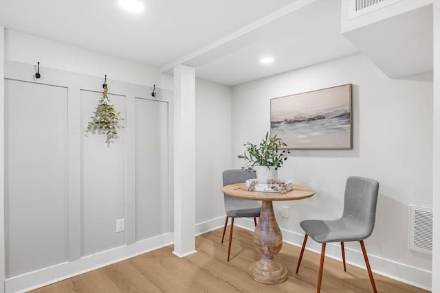 dining space with breakfast area and wood-type flooring