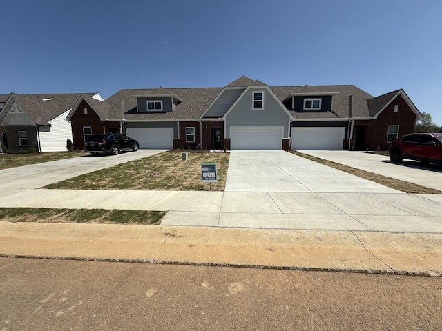 craftsman-style house featuring concrete driveway and brick siding
