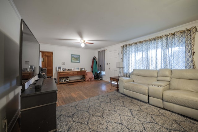 living room featuring dark hardwood / wood-style flooring, ornamental molding, and ceiling fan