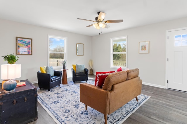 living area with ceiling fan, baseboards, and wood finished floors